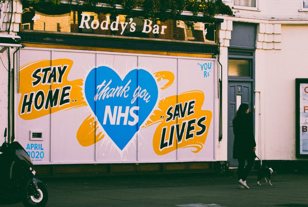 Shuttered pub front that says 'Stay home. Thank you NHS. Save lives"