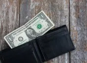 one dollar bill in black wallet